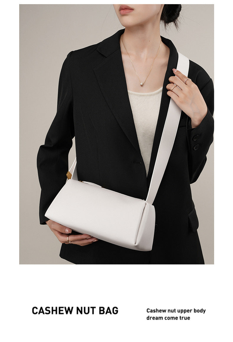 White pillow crossbody bag styled with a black blazer