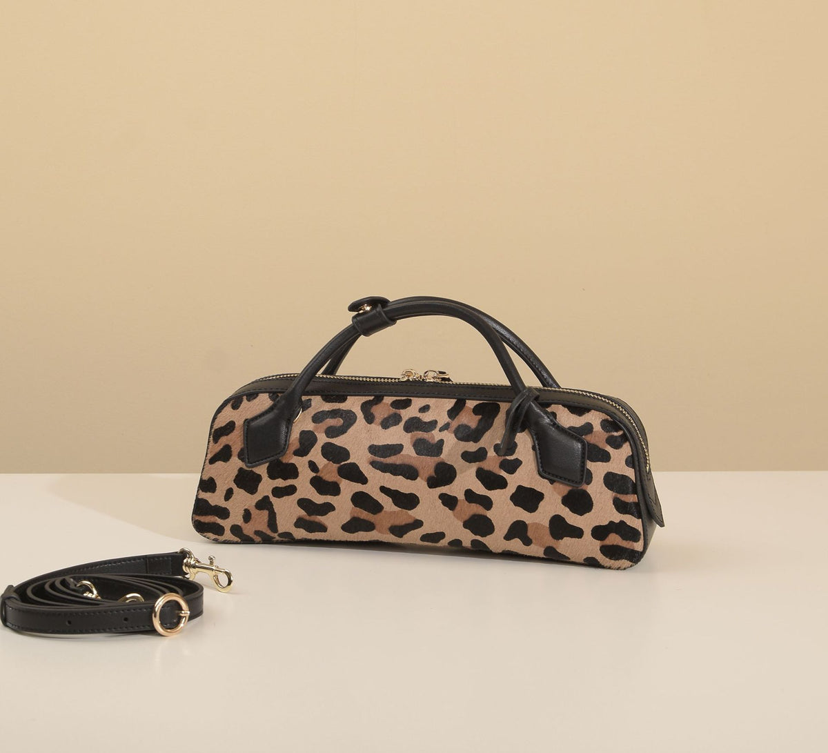 Front view of leopard-print bag with its removable strap