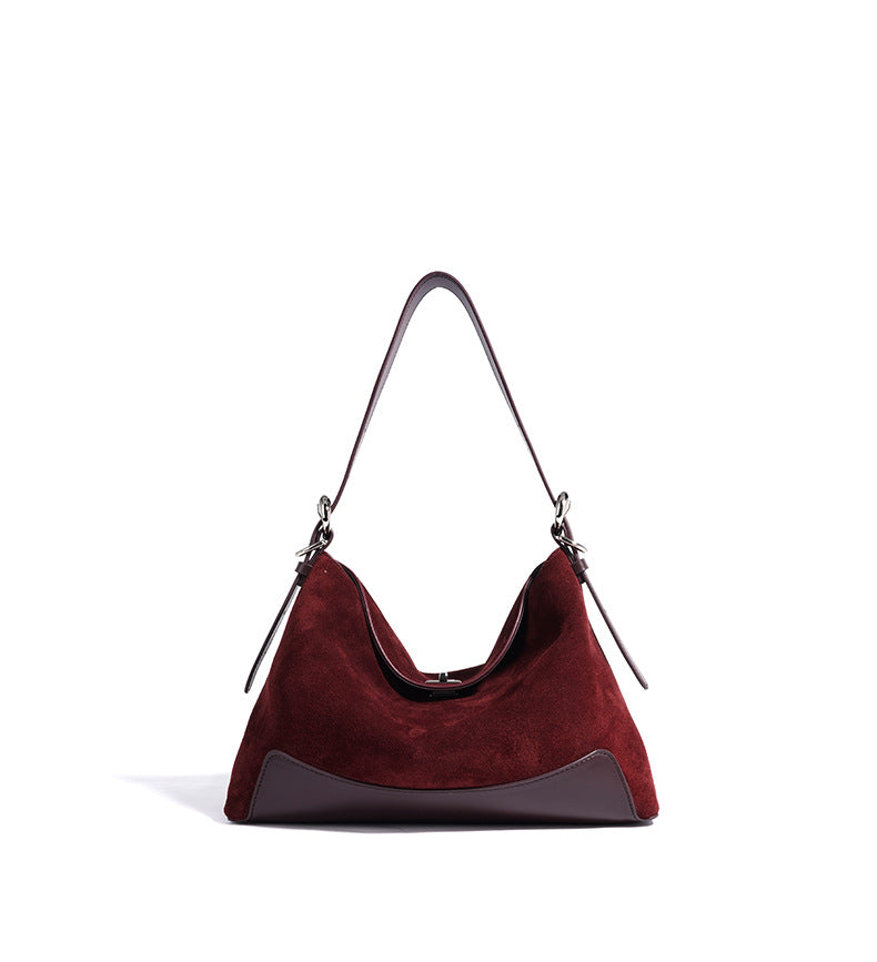 Front view of the brown tote and curved top opening
