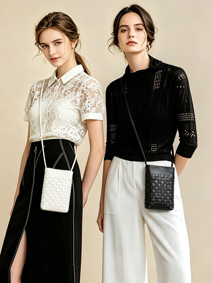 Two models wearing black and cream white woven phone bags styled with casual outfits