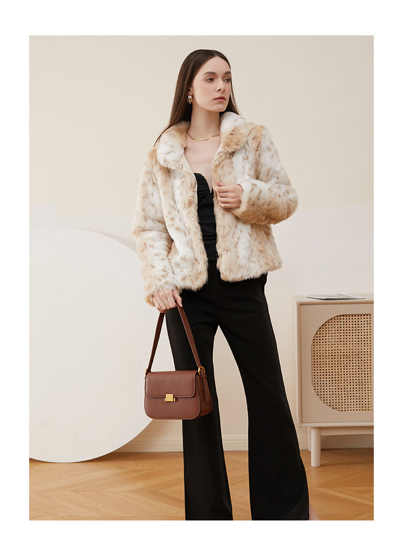 Full-length model shot in faux fur coat carrying caramel leather shoulder bag