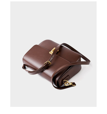 Brown cowhide crossbody bag top-down view showing both included straps