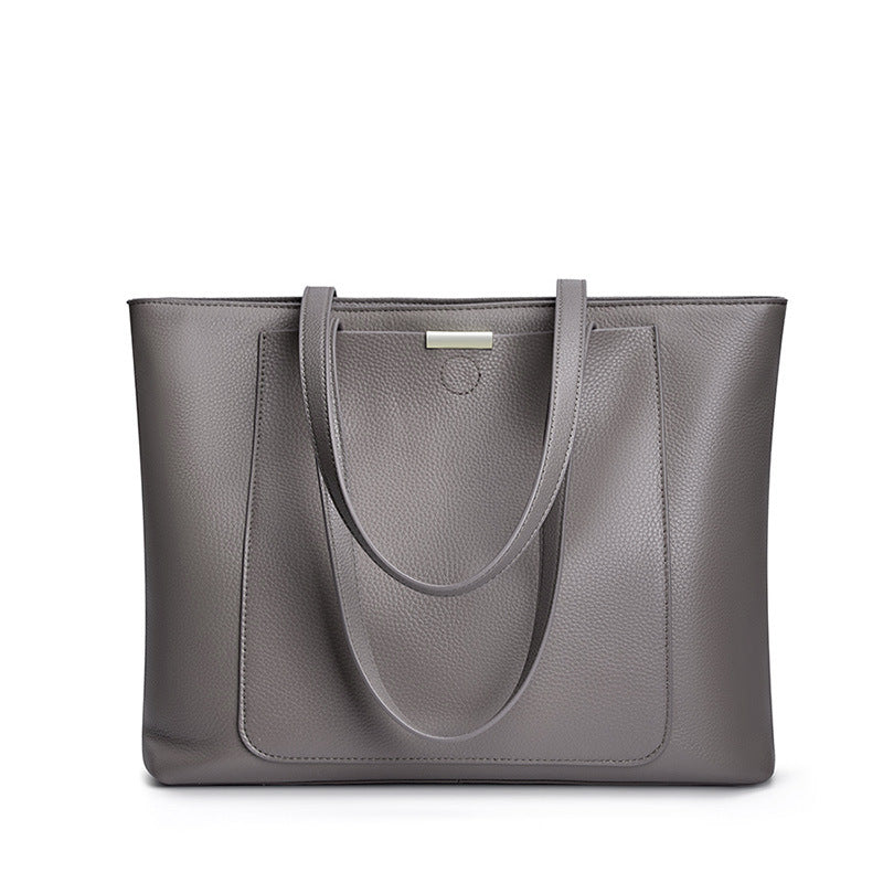 Front view of dark gray pebbled leather tote bag with dual straps on white background