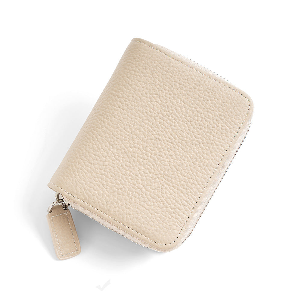 Ivory pebbled leather compact wallet with zip-around design