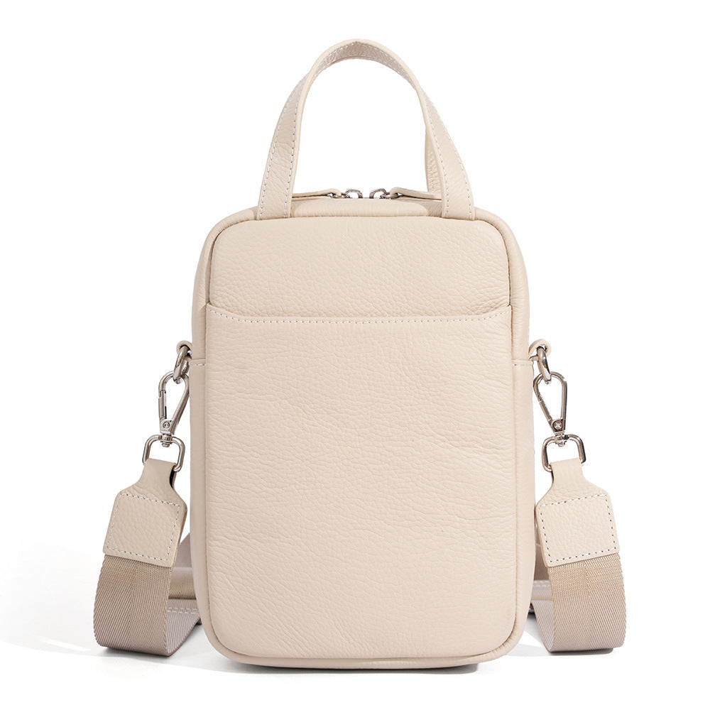 Off white pebbled leather mini crossbody phone bag with silver-tone hardware and woven shoulder strap
