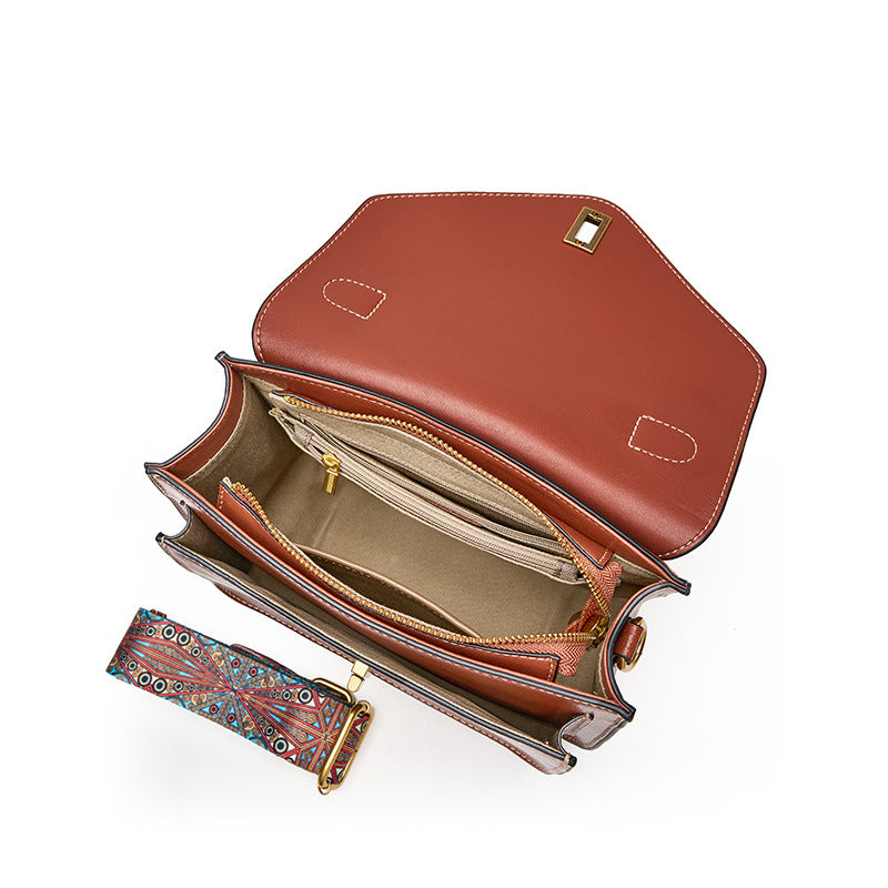 Interior view of brown leather messenger bag showing zip pocket, card slots, and slip pockets