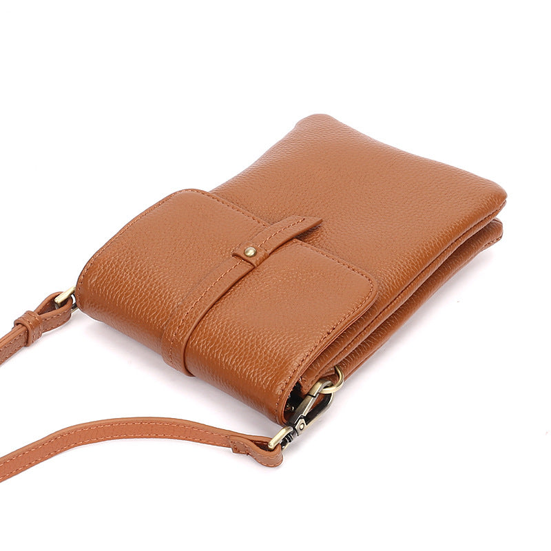 Caramel leather phone bag angled view showing strap attachment and flap detail