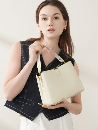 Model holding the off-white leather bucket bag