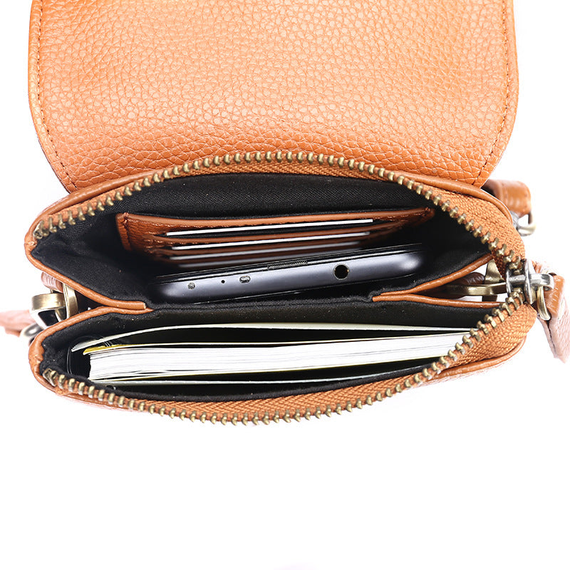 Interior view of caramel leather crossbody bag showing card slots and zippered compartment