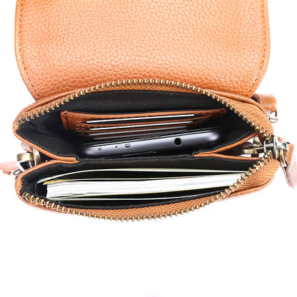 Interior view of caramel leather crossbody bag showing card slots and zippered compartment