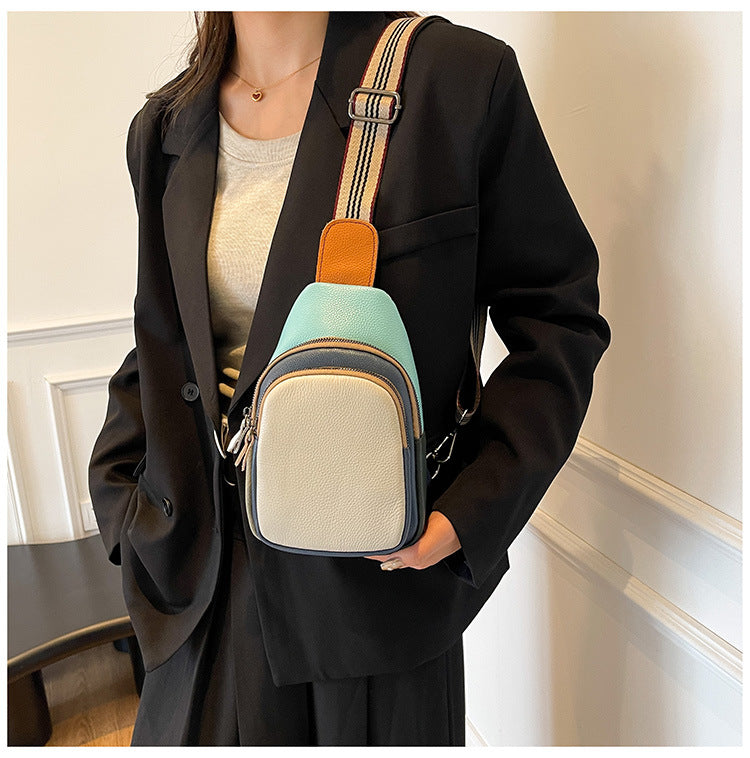 Cream and turquoise sling bag styled with a black outfit