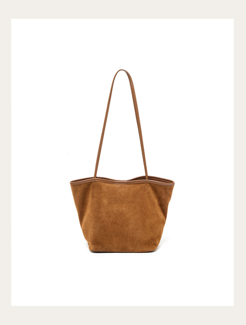Caramel suede bucket tote on a clean background