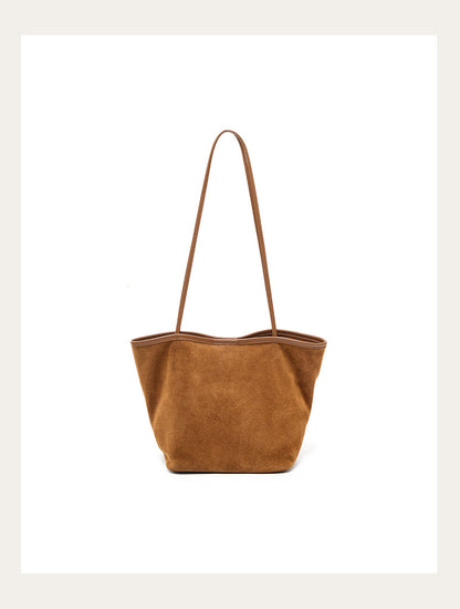 Caramel suede bucket tote on a clean background