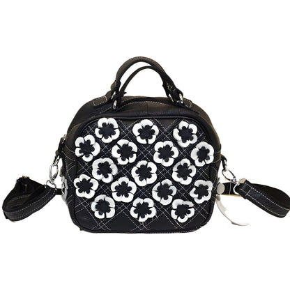 Back view with a zippered exterior pocket and diamond stitching