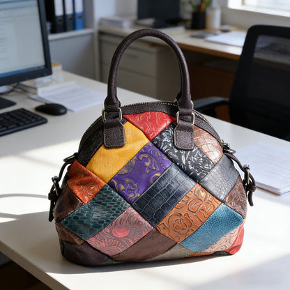 Multicolor embossed cowhide patchwork bag with top handles on a desk