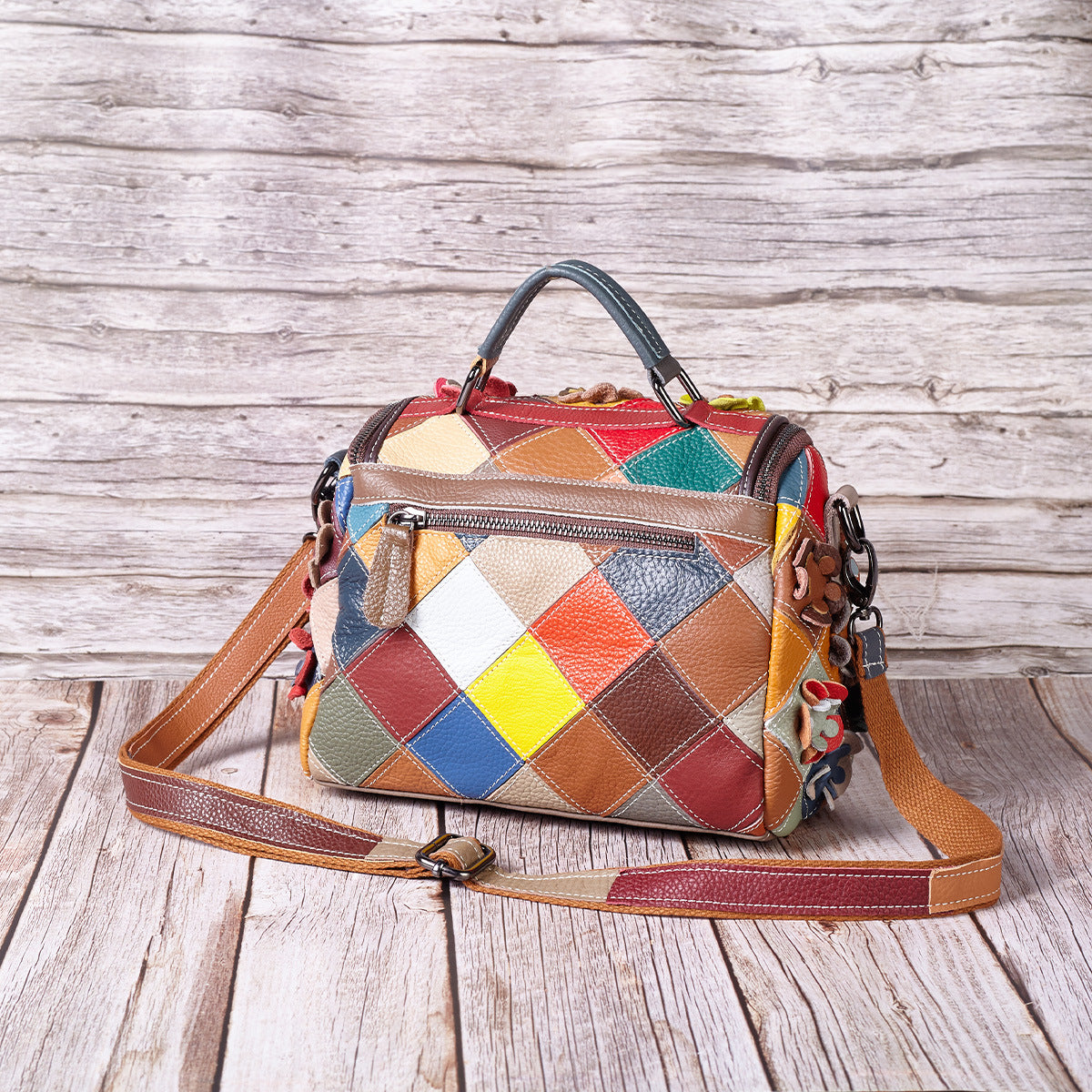Rear view showing the bag's geometric patchwork and zip pocket