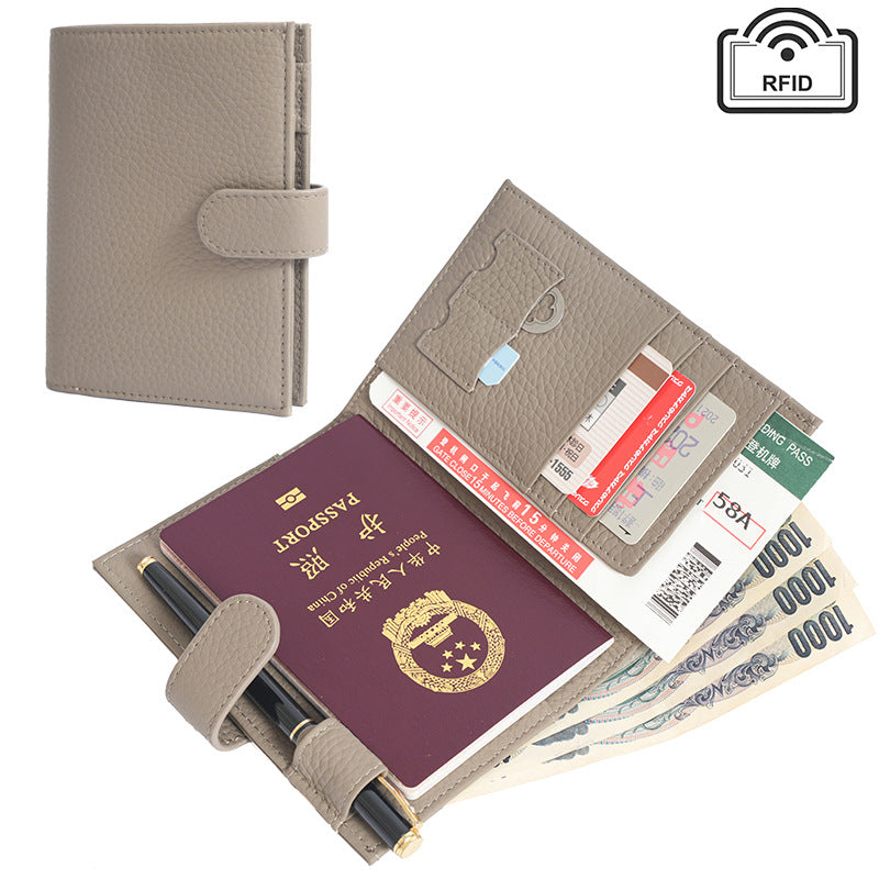 Light grey leather passport case open to reveal the interior card slots and pen holder