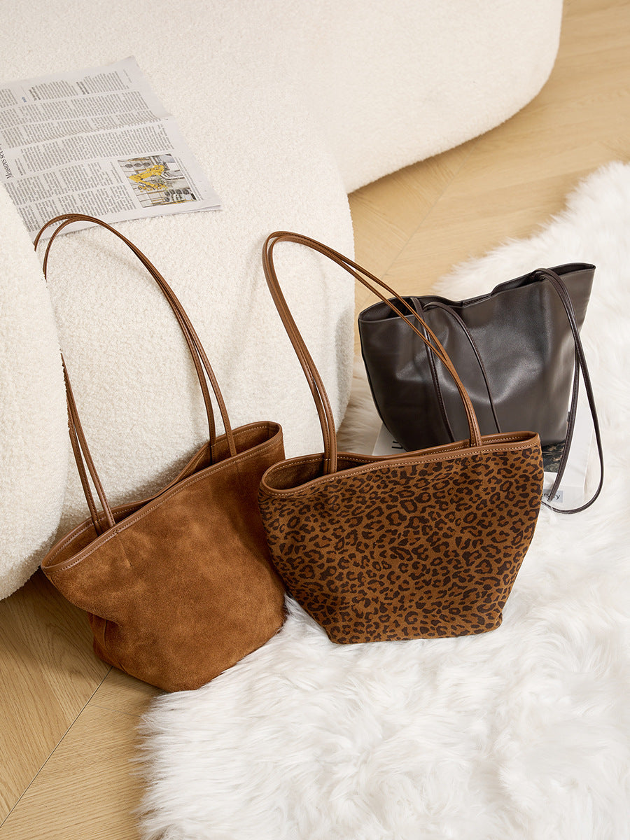 Three suede tote colorways shown together
