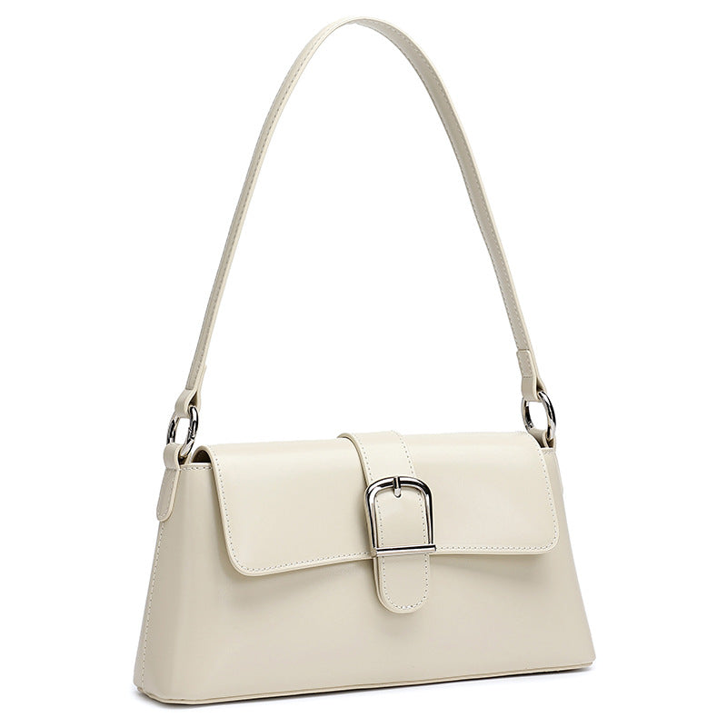 White genuine leather baguette shoulder bag on white background