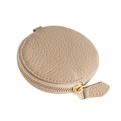 Ivory round leather coin purse side view showing zipper detail