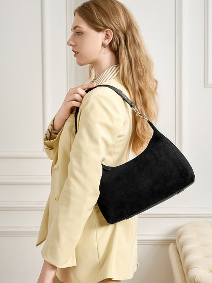 Black suede-finish shoulder bag worn over the shoulder