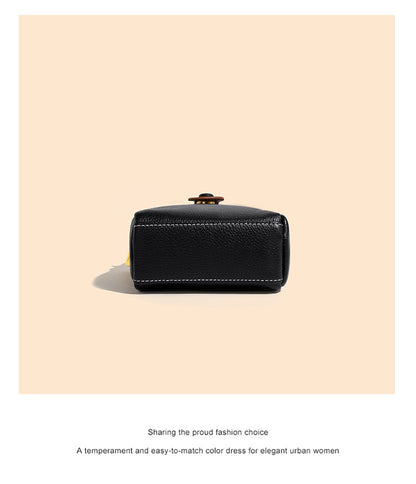 Top-down view of black cowhide bag showing base stitching and structured rectangular shape
