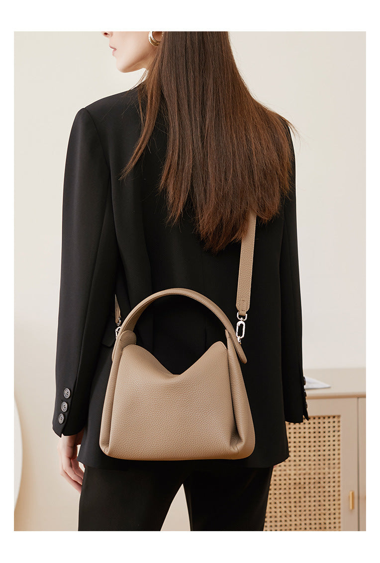 Back view of model wearing pebbled leather crossbody bag