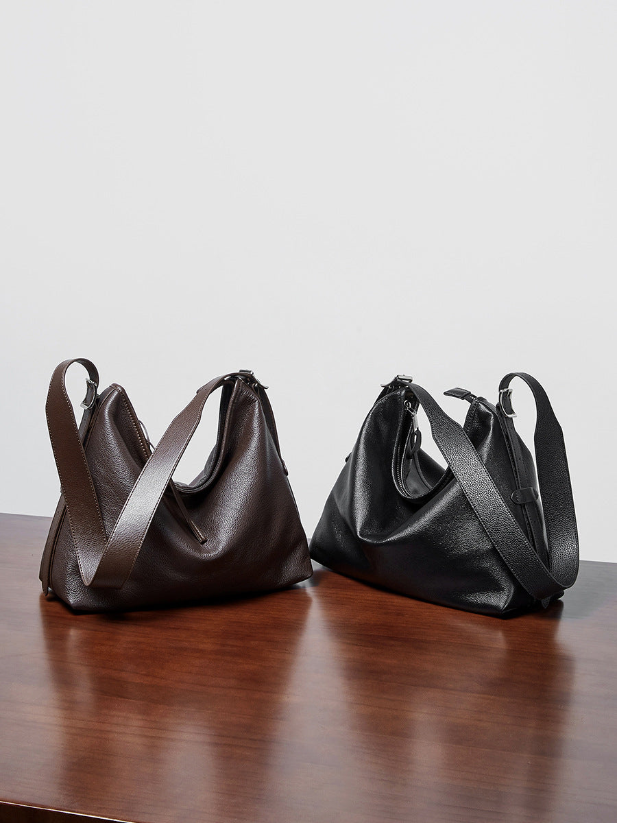 Black and Havana leather bags side by side on a table