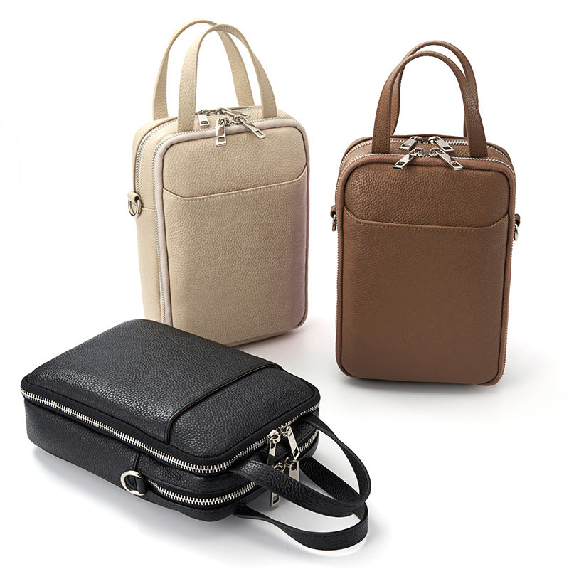 Three colorways of the vertical phone crossbody in beige, dark brown, and black arranged together