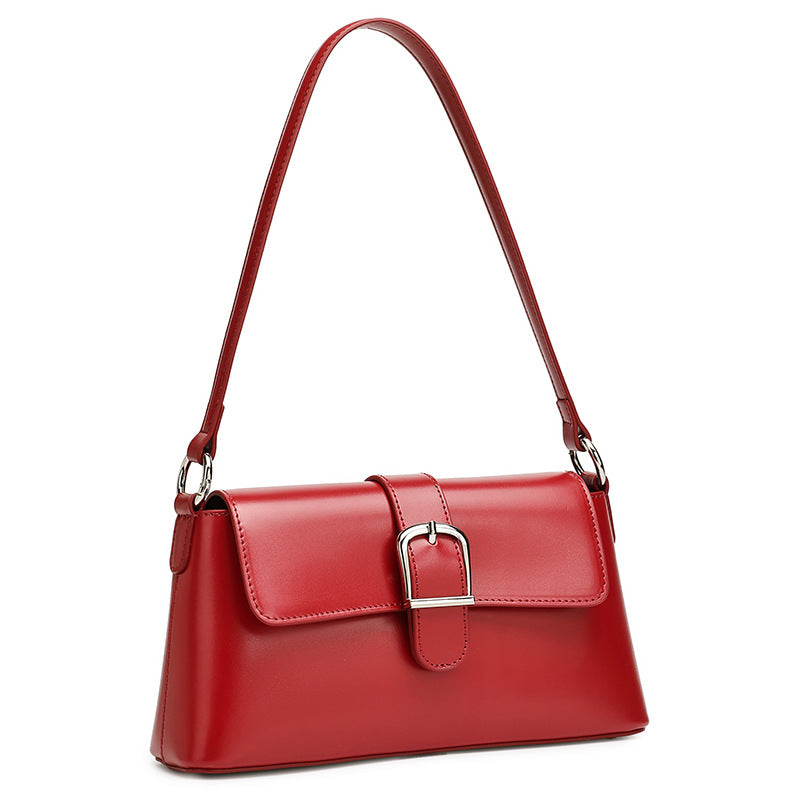Red genuine leather baguette shoulder bag on white background
