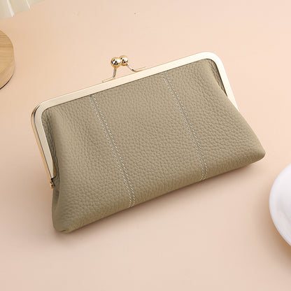 Gray shell-shaped leather clutch shown from the front