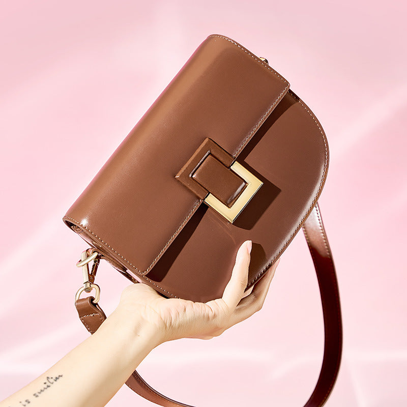 Hand-held close-up of the brown saddle bag turn-lock