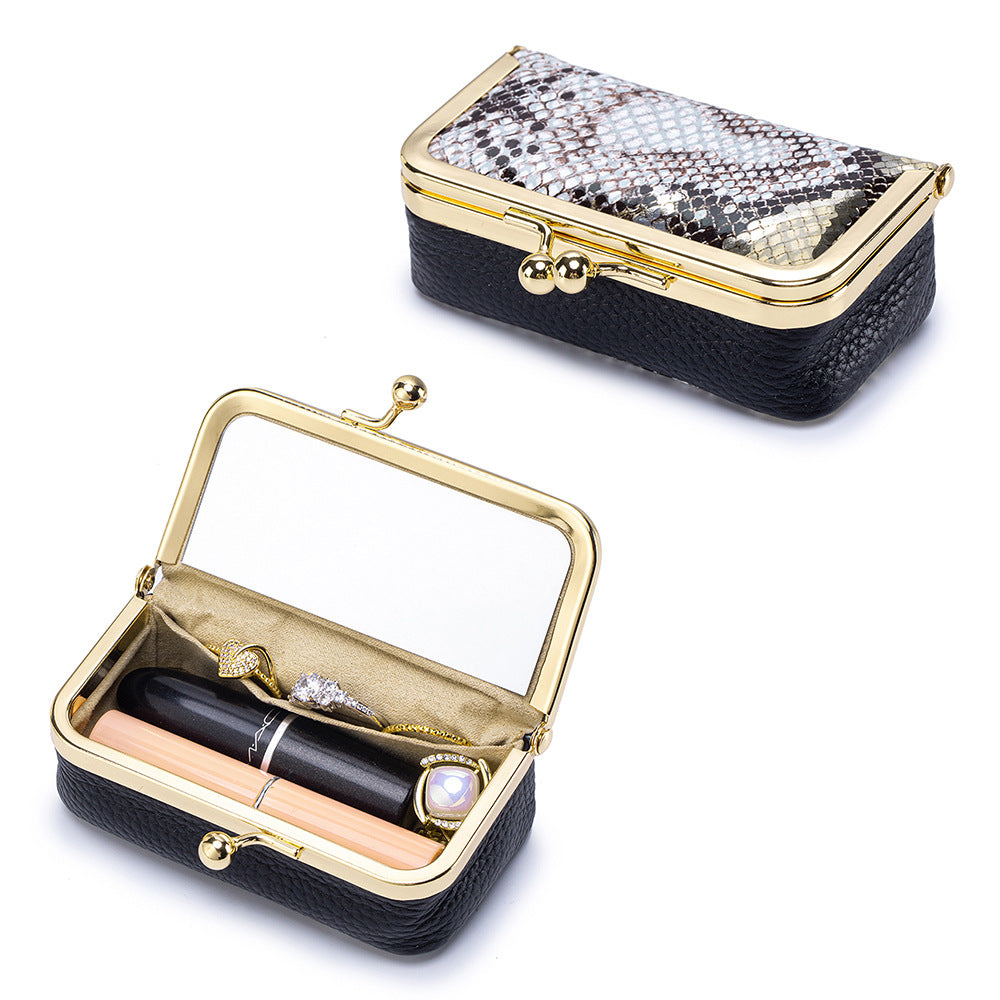 Black pebbled pouch open beside lipstick and jewelry