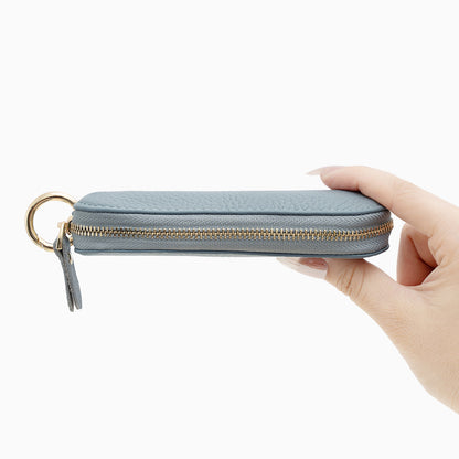 Side view of light blue mini zip pouch showing full top zipper and keyring