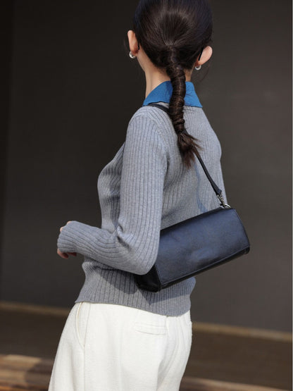 Black shoulder bag shown from a rear three-quarter angle