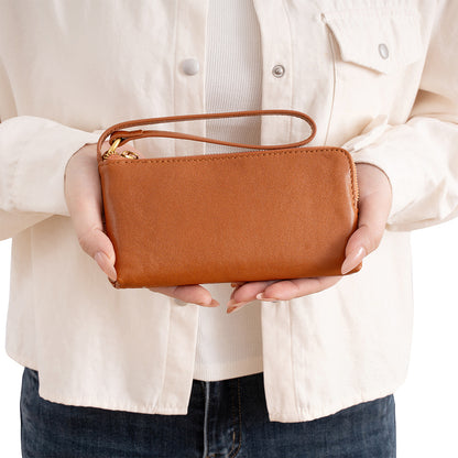 Coffee brown cowhide leather long wallet held in hands showing slim profile