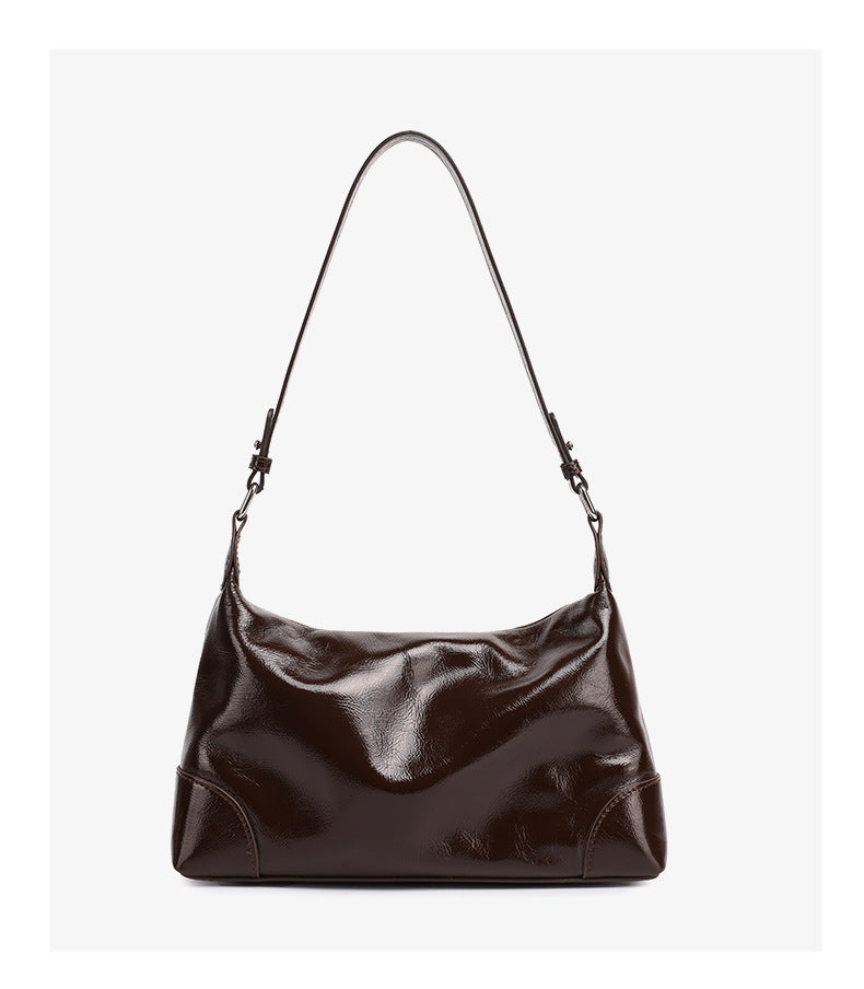 Front view of coffee brown cowhide leather shoulder bag with curved flap