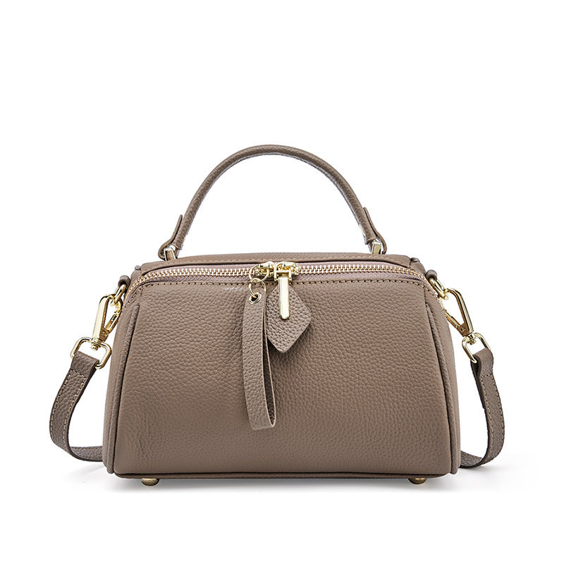 Gray top-grain cowhide mini Boston bag with pebbled texture and rolled top handle