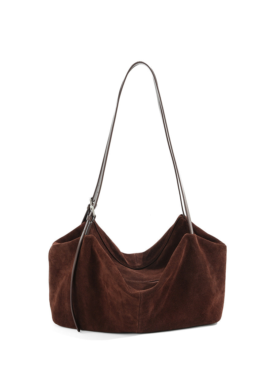 Front view showing the relaxed silhouette and stitched panels of the tote