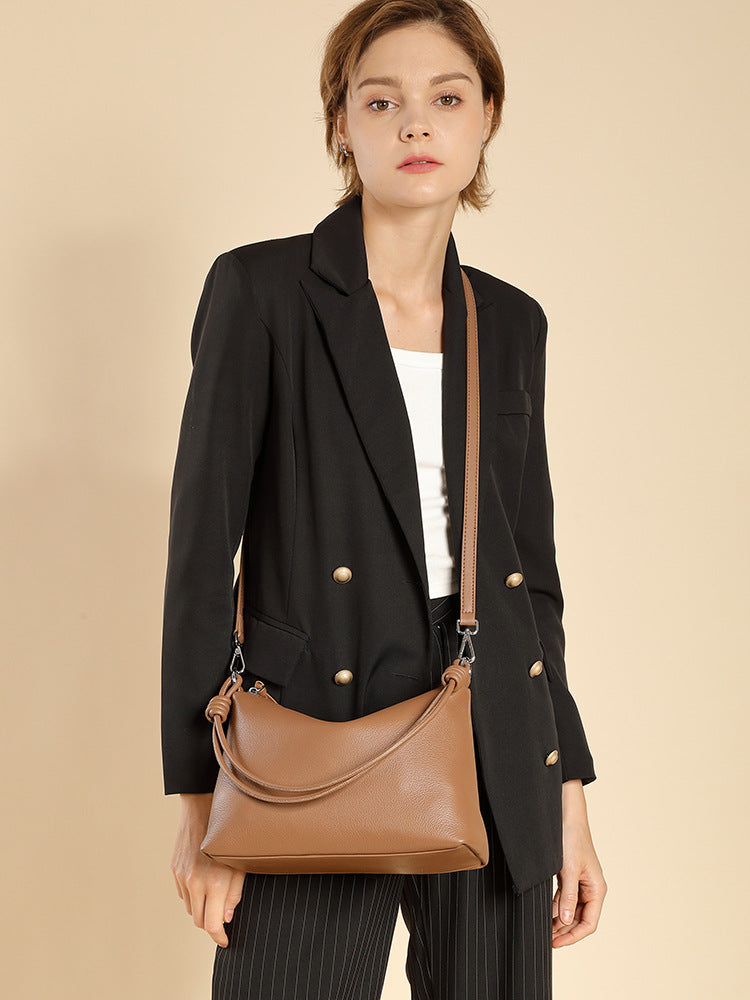 Model wearing caramel pillow tote with adjustable crossbody strap