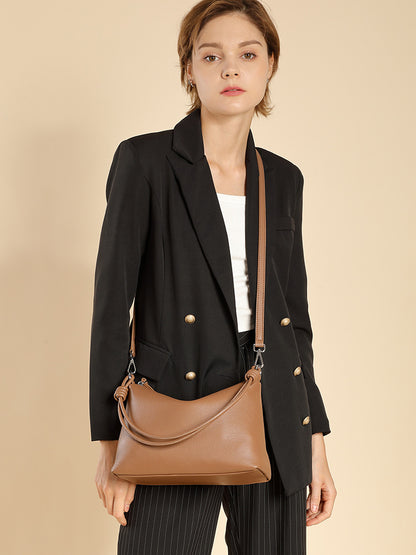 Model wearing caramel pillow tote with adjustable crossbody strap
