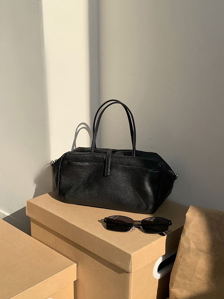 Black Boston bag displayed on a surface