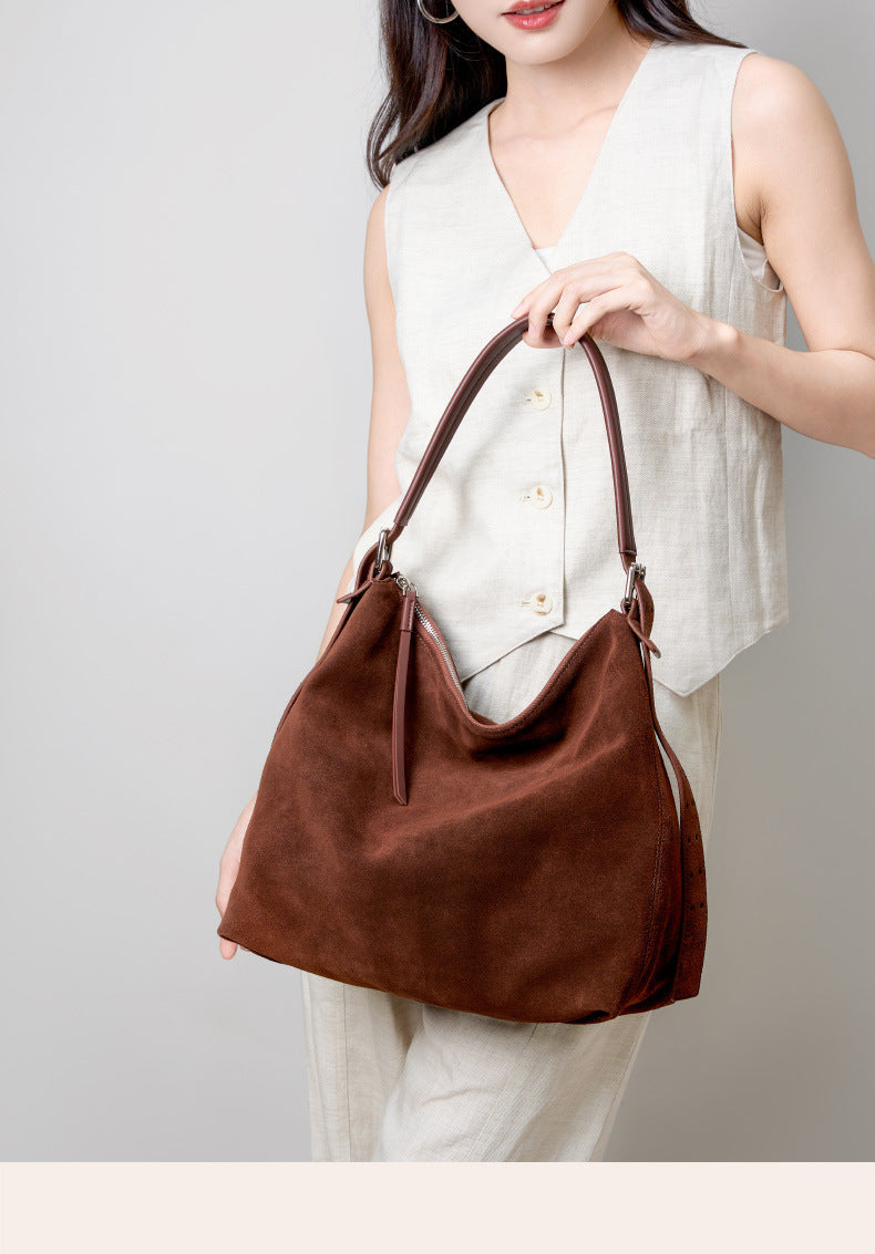 Front view of the coffee-colored tote and long shoulder strap