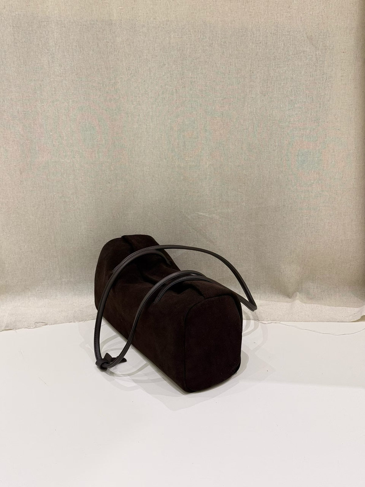 Black Boston tote photographed upright against fabric