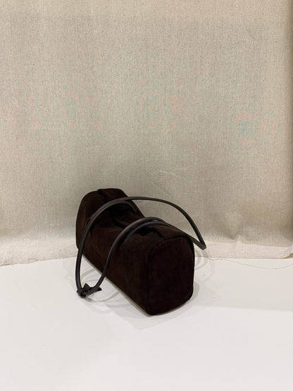 Black Boston tote photographed upright against fabric