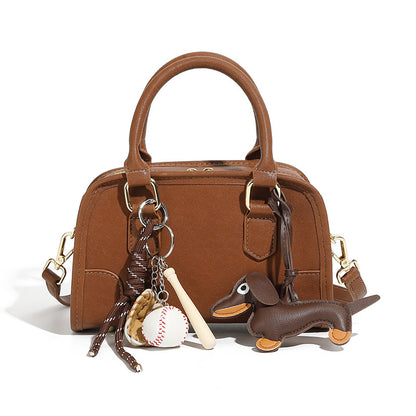 Brown split leather mini bowling bag with top handle and bag charms