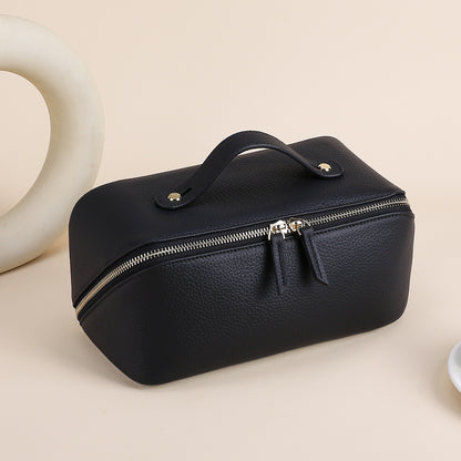 Black pebbled cowhide cosmetic pouch with top handle and double zipper