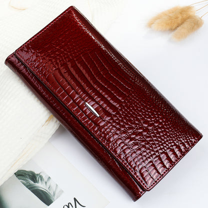 Burgundy cowhide clutch wallet showing its glossy geometric texture