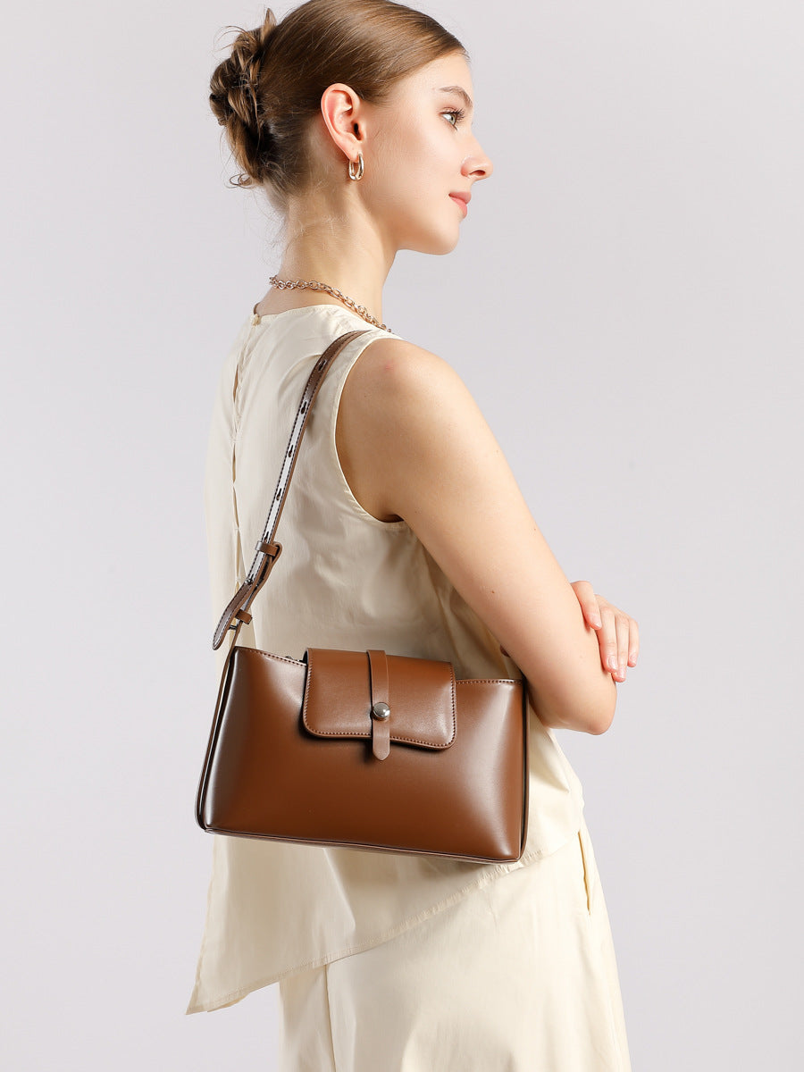 Model wearing brown leather shoulder bag crossbody