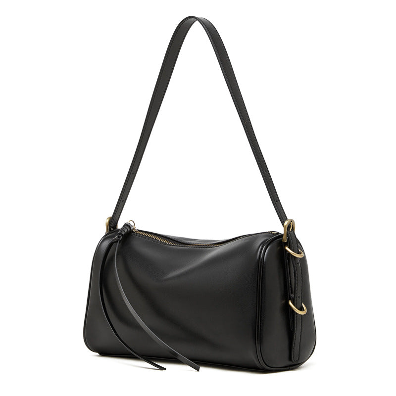 Black cowhide leather crossbody bag with adjustable shoulder strap on white background